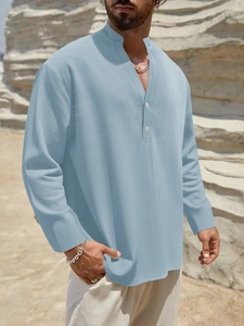 Detail of light blue linen-blend fabric and stand collar on men's casual button shirt