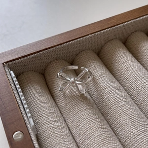 925 sterling silver bow knot open ring displayed in a luxury wooden jewelry box