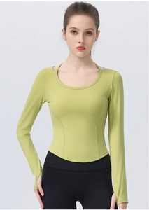 Detail showing avocado green yoga top with thumb holes and ergonomic curved hemline