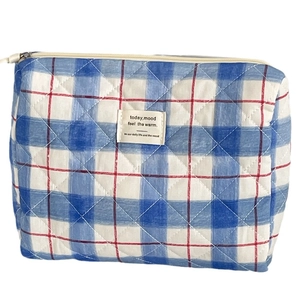 Quilted blue and red plaid makeup bag with cotton fabric and white zipper closure