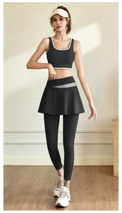 Detail of high-elastic black yoga set with pleated skirt leggings and white piping vest