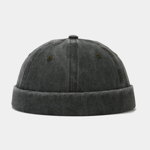 Close-up of vintage washed charcoal grey brimless cap with textured cotton fabric