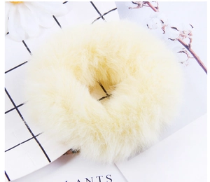 Close-up of soft beige faux fur hair tie with high-elasticity texture for hair styling