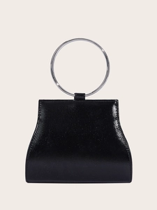 Detail of glossy black patent leather evening bag with large silver metal ring handle