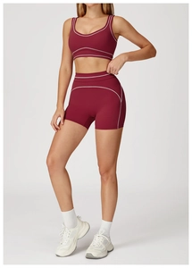 Detail of dark burgundy yoga set with white contrast stitching and high waist fit