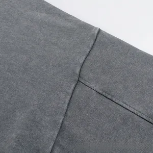 Detail shot of vintage washed grey cotton fabric with visible twill texture and neat stitching