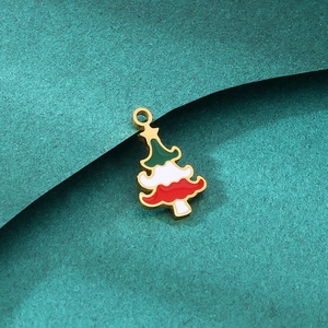 Macro detail of Christmas tree charm with red green enamel stripes and golden metal edge