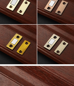 Magnetic cabinet door catches in gold, antique bronze, and nickel finishes on wood