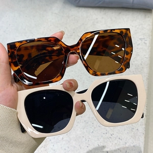 Detail of tortoise shell and beige oversized polygon sunglasses with premium lenses