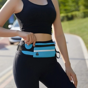Close-up of blue sports waist bag with reflective strip and functional compartments