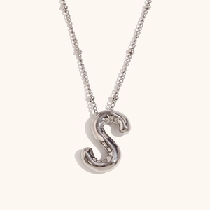 Detailed macro view of 18K silver-plated alphabet S balloon pendant with polished mirror finish
