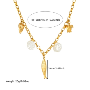 Gold plated ocean themed necklace with shell fish and turtle pendants on white background