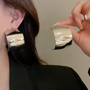 Chunky silver C-hoop earrings with a mirror-finish metal surface for a minimalist look