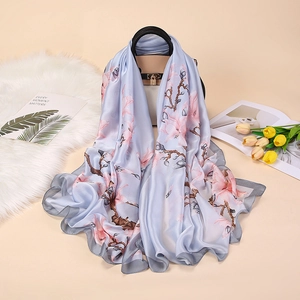 Elegant floral satin scarf with pink blossoms on light blue silk-like drape fabric