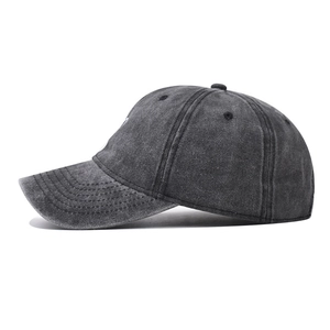 Detail view of washed dark grey cotton baseball cap with vintage finish and side profile