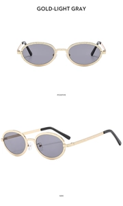 Macro detail of gold metal frame with light gray lenses and textured temples