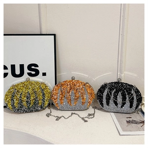 Detailed view of three luxury oval evening clutches with sequins and metal chain straps