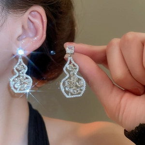 Macro view of silver gourd earrings with zircon pave and internal rose detailing