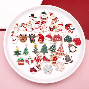 Assorted Christmas alloy pendants featuring Santa, snowman and deer in a white tray