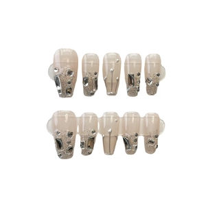 Handmade coffin nails in nude pink with silver glitter gradient and 3D rhinestones