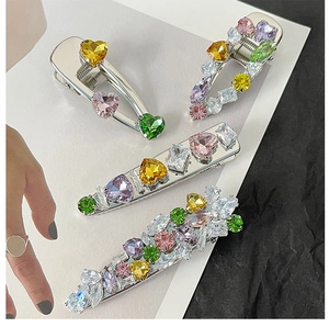Set of four silver metal hair clips with colorful heart-shaped cubic zirconia stones