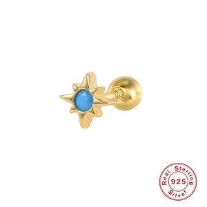 Macro detail of gold S925 sterling silver star stud with blue gemstone and ball back