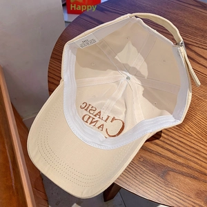 Detail of beige cotton baseball cap with CLASSIC AND embroidery on the inner brim