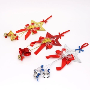 Close-up of sparkling Christmas star ornaments with festive ribbons and bells set