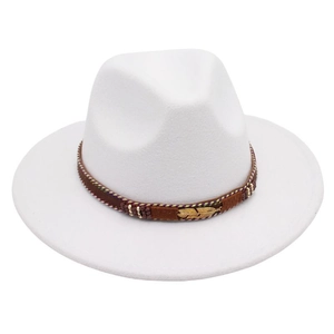 Detail of white fedora hat featuring golden feather metal and ethnic woven band