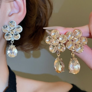Macro shot of sparkling crystal flower teardrop earrings with a polished silver-tone finish