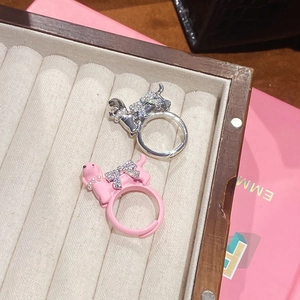 Close-up of cute dog rings with zircon bow and pearl collar in a jewelry display box