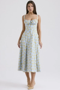 Close-up of light blue floral midi dress with ruched bust and tie detail in studio setting