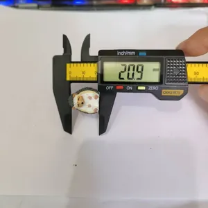 Close-up measurement of a cute hedgehog figurine showing a size of 20.9mm with a caliper