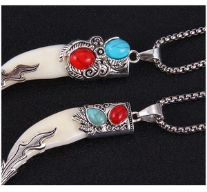Macro view of vintage wolf tooth necklaces with silver accents and turquoise stones