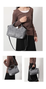Detail view of a vintage gray soft leather tote bag showing crossbody and shoulder options