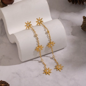 Golden sunburst tassel earrings with sparkling zircon stones in a long fringe design