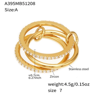 Detailed view of gold plated stainless steel multi-layered ring with zircon and lock charm