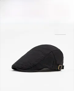 Detail of black flat cap showing breathable mesh fabric and metal side buckle