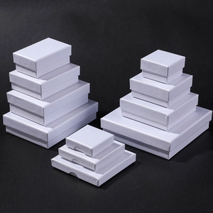 Detailed stack of white textured jewelry boxes in various sizes for rings and necklaces