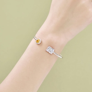 Detail of S925 sterling silver spring bangle with yellow and white zircon stones