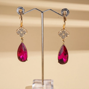 Retro gold earrings featuring a red teardrop gemstone and a clover zircon stud