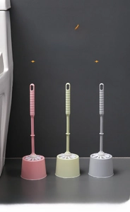 Detail of toilet brush set with ergonomic handle and base in three pastel colors