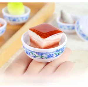 Macro shot of realistic miniature Dongpo pork in a blue and white porcelain bowl