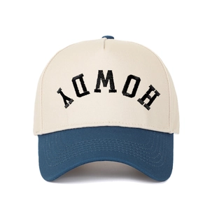 Close-up of HOWDY embroidery on a two-tone cotton baseball cap with contrast brim
