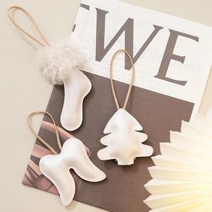 Set of 3 white faux leather Christmas ornaments featuring a stocking, tree, and angel wings
