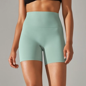 Close-up of mint green high-waisted yoga shorts showing elastic fabric texture