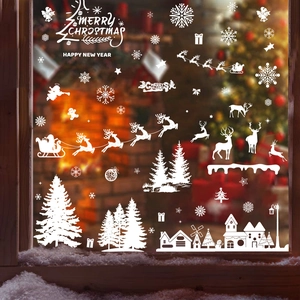 White Christmas window decals featuring Santa, reindeer and snowflakes on glass