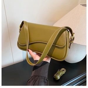 Close-up of olive green retro crossbody bag with textured leather and adjustable wide strap