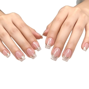 French nude press-on nails with silver glitter gradient and gold metallic curved line detail