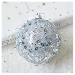 Close-up of silver Christmas ornament with glitter sequins and snowflake pattern